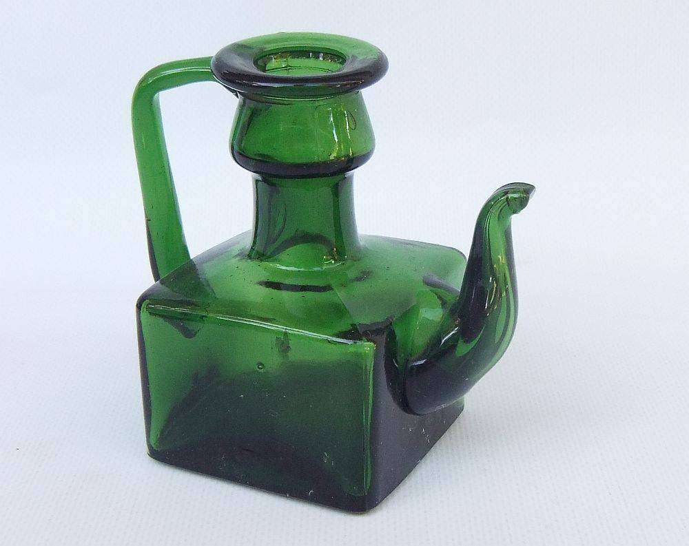 An interesting old green glass vessel