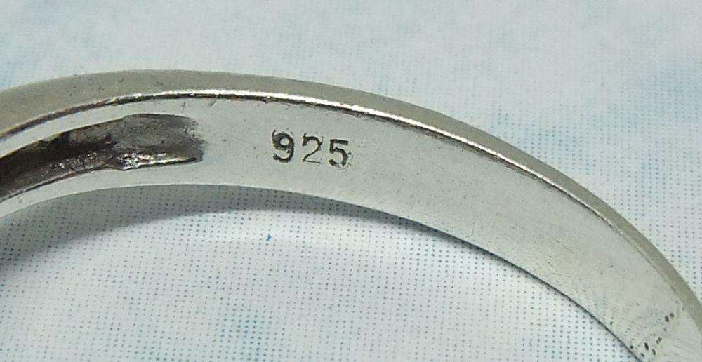 AN ENGAGEMENT STYLE SOLID STERLING SILVER RING SET WITH FACETED CZ STONES