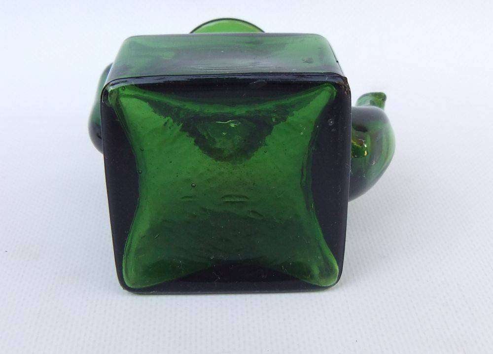An interesting old green glass vessel