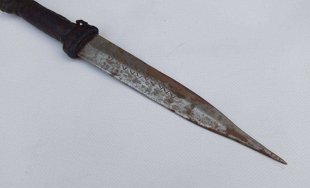 A rare antique North African Tuareg tribal dagger with leather sheath and handle