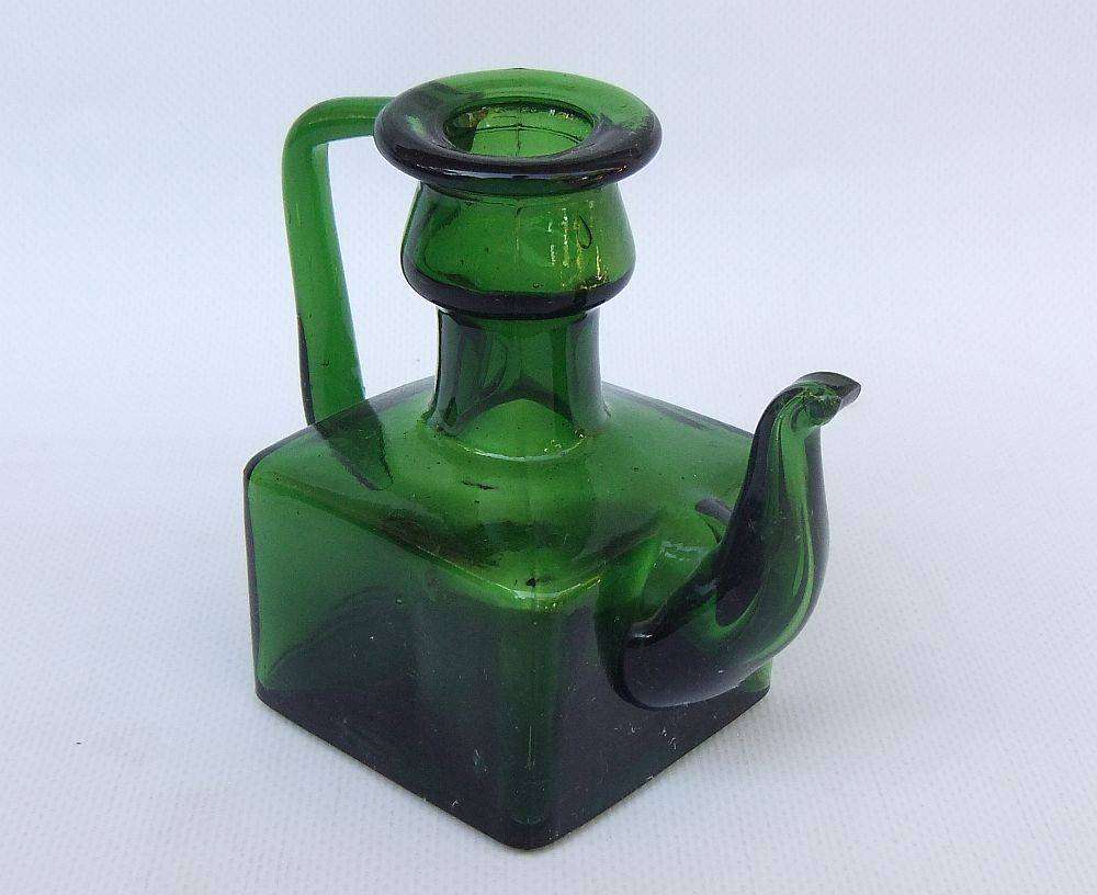 An interesting old green glass vessel