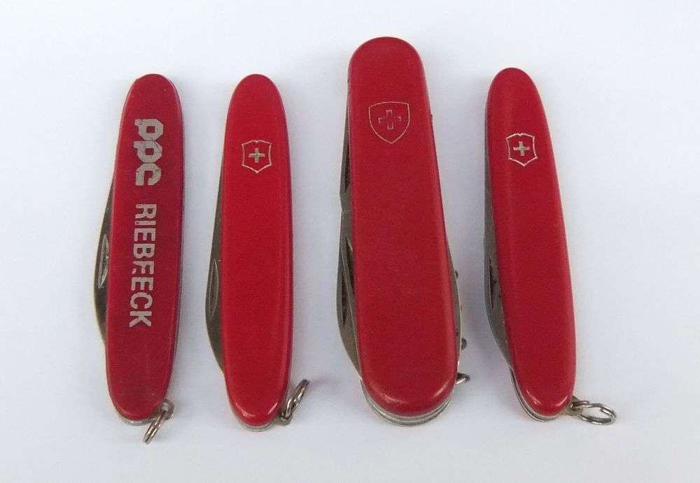 THREE VINTAGE VICTORINOX POCKET KNIVES  AND A NO NAME POCKET KNIFE WITH ADVERTISING