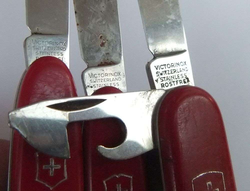 THREE VINTAGE VICTORINOX POCKET KNIVES  AND A NO NAME POCKET KNIFE WITH ADVERTISING