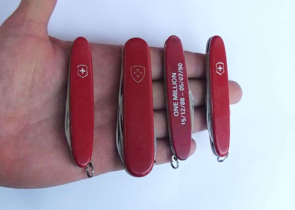 THREE VINTAGE VICTORINOX POCKET KNIVES  AND A NO NAME POCKET KNIFE WITH ADVERTISING