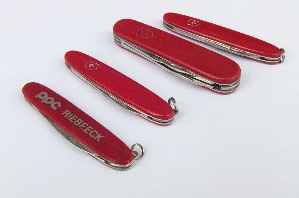 THREE VINTAGE VICTORINOX POCKET KNIVES  AND A NO NAME POCKET KNIFE WITH ADVERTISING