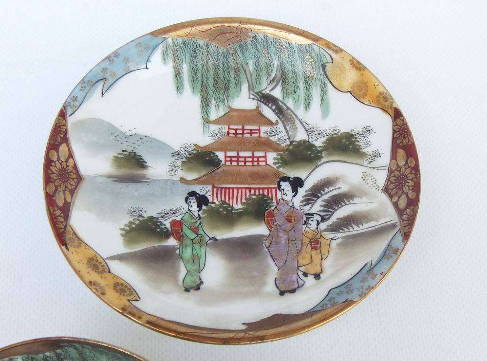 A stunning signed hand painted antique Japanese porcelain duo