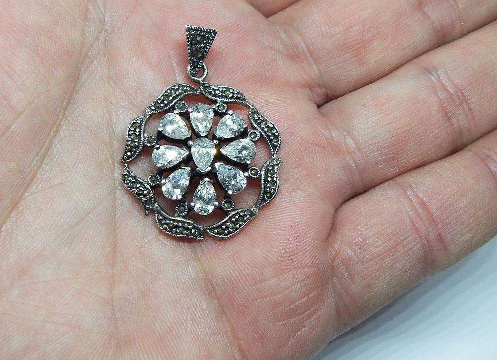 An exquisite vintage style sterling silver pendant with faceted insets and marcasite
