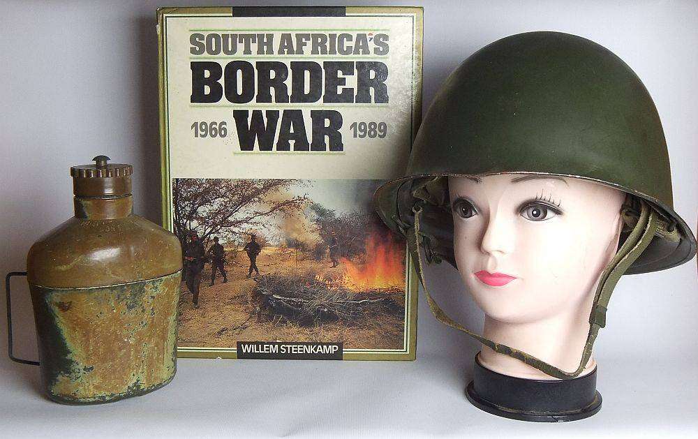 A vintage SA army helmet , water bottle and a book about the South African Border War