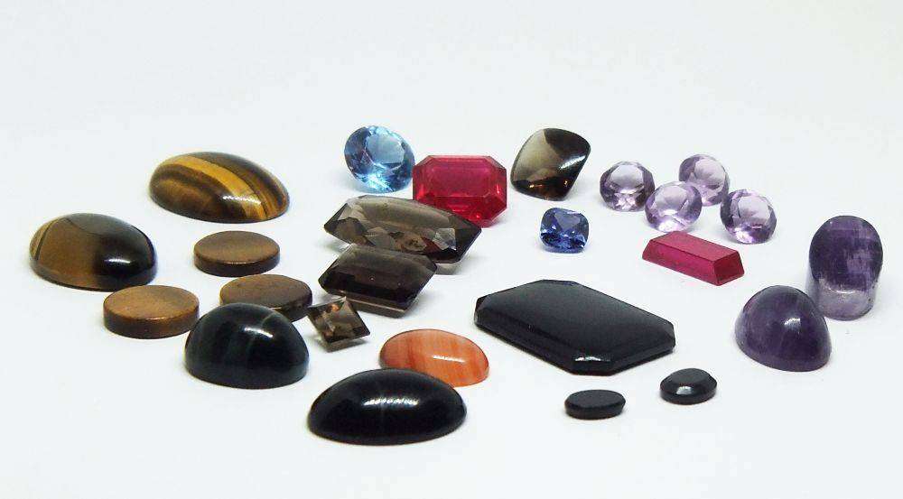 Various gorgeous cabochon and faceted stones removed from gold jewelry