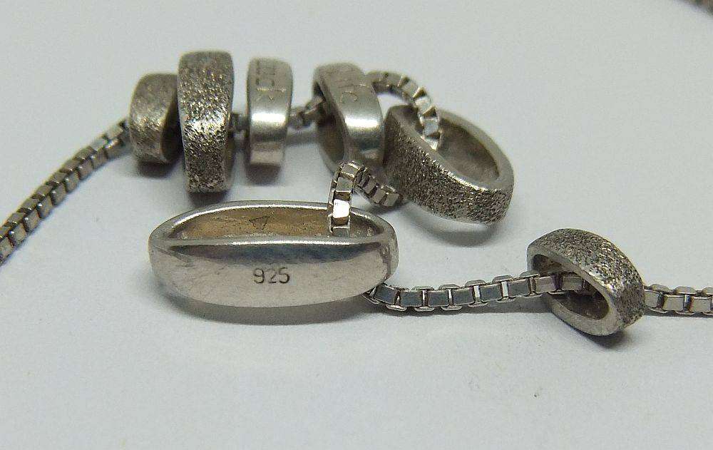 A quality sterling silver necklace with unique "Love, Life, Luck" theme pendants in great condition