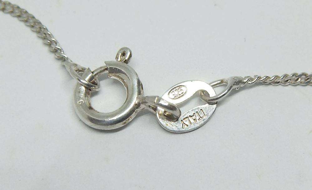 A detailed vintage Egyptian silver pendant with a sterling silver necklace