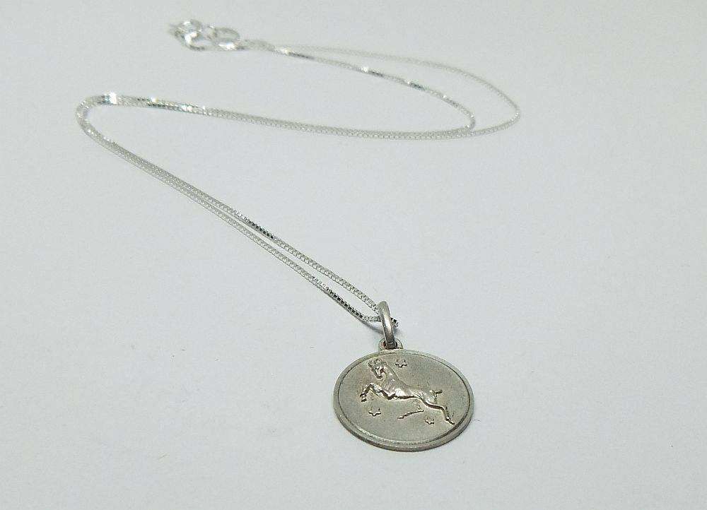 A vintage sterling silver Capricorn Zodiac sign pendant with a sterling silver necklace