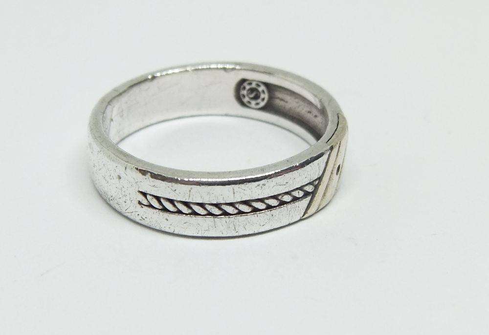 A stylish South African designer sterling silver mens wedding band with gold accent and stone