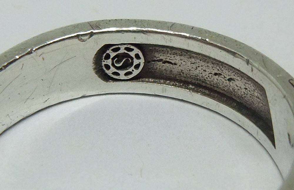 A stylish South African designer sterling silver mens wedding band with gold accent and stone