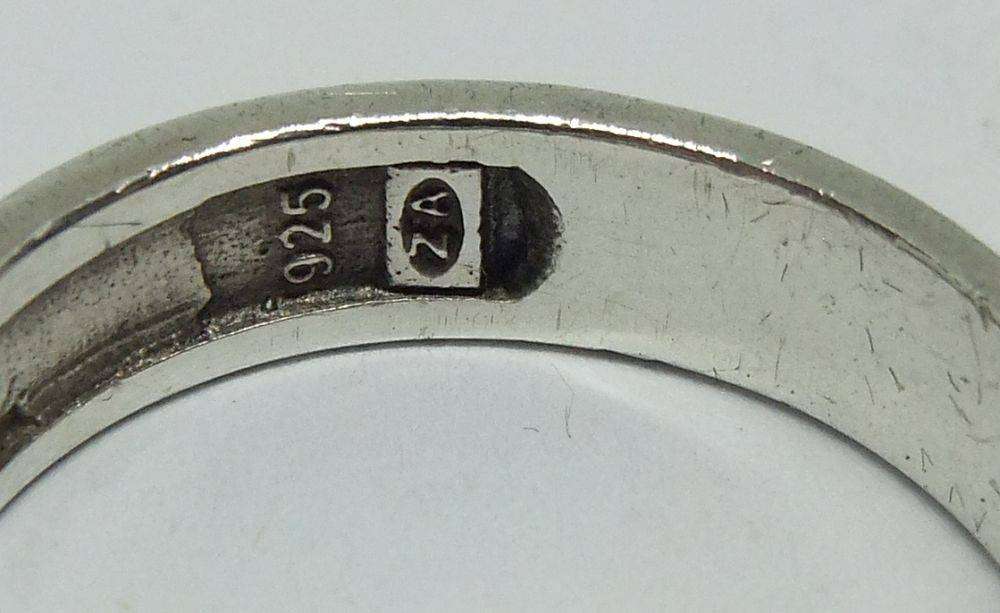 A stylish South African designer sterling silver mens wedding band with gold accent and stone