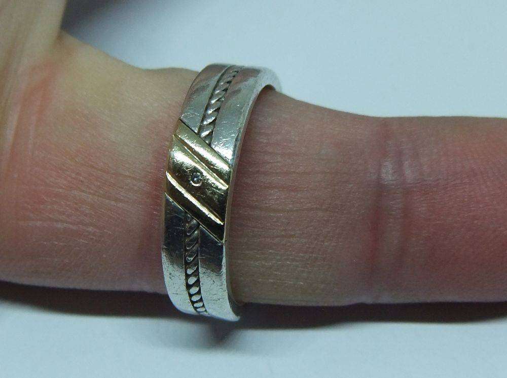 A stylish South African designer sterling silver mens wedding band with gold accent and stone