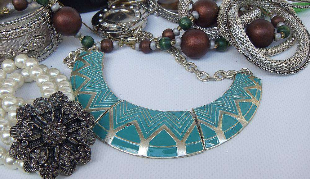 A rusty old tin filled with loads of usable jewelry and spare parts