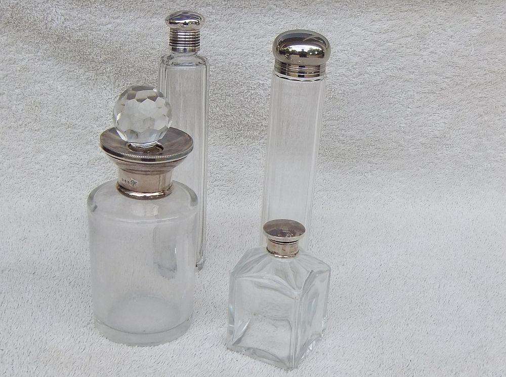 AN ANTIQUE BOTTLE WITH HALLMARKED SILVER COLLAR DATED 1918 , ANOTHER WITH SILVER LID PLUS 2 MORE !!