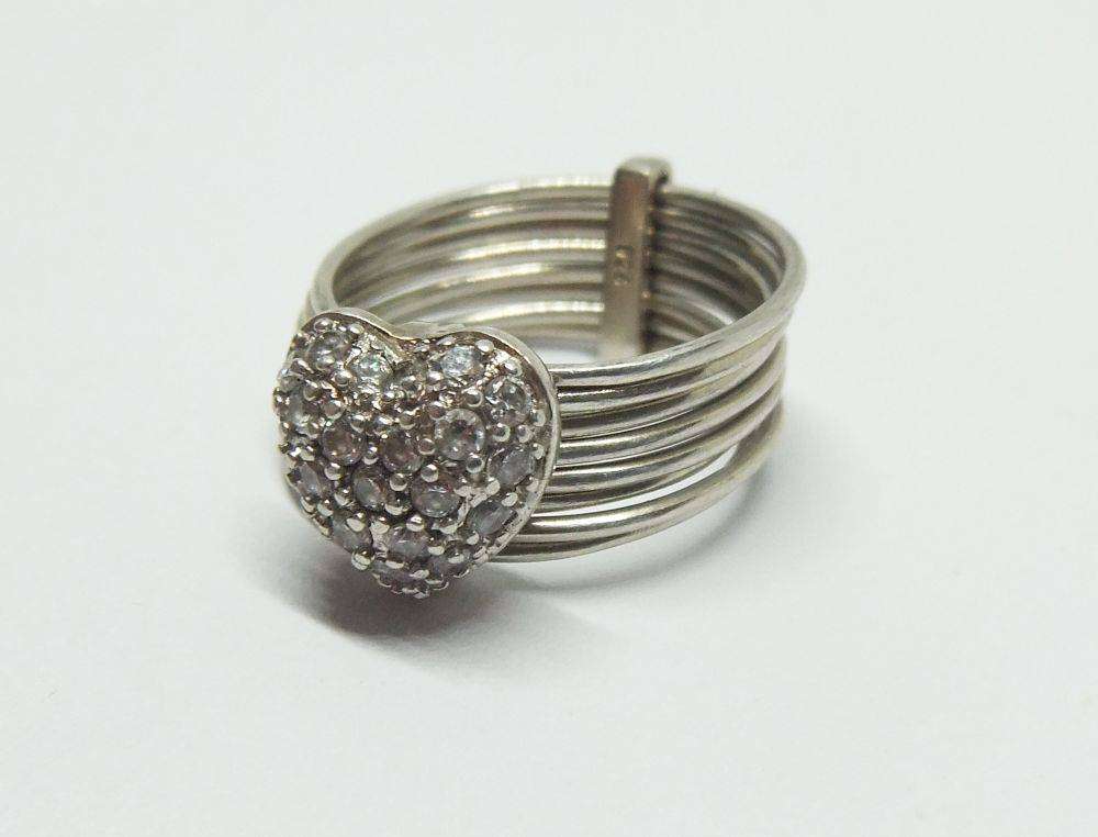 A beautiful sterling silver 8 in 1 ring with heart feature set with faceted clear CZ stones