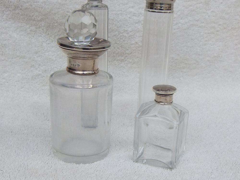 AN ANTIQUE BOTTLE WITH HALLMARKED SILVER COLLAR DATED 1918 , ANOTHER WITH SILVER LID PLUS 2 MORE !!