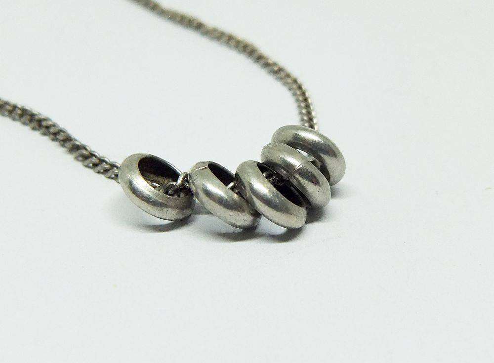 A charming sterling silver necklace with five friendship rings in great condition