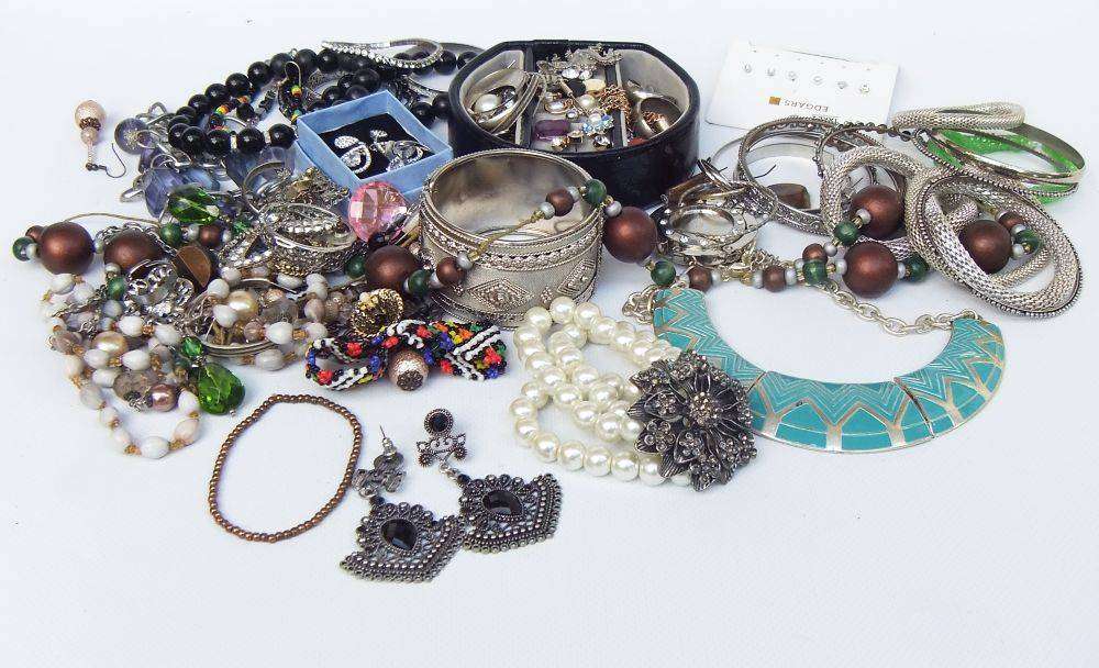 A rusty old tin filled with loads of usable jewelry and spare parts