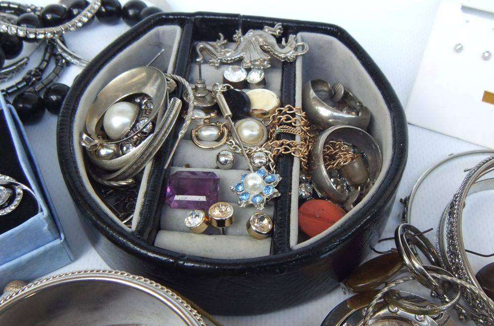 A rusty old tin filled with loads of usable jewelry and spare parts