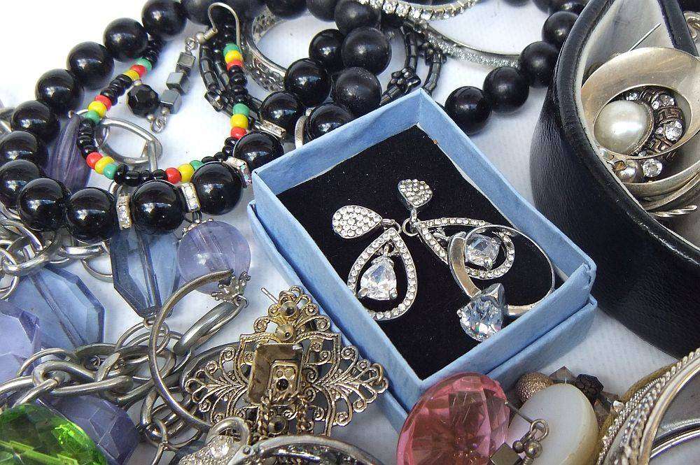 A rusty old tin filled with loads of usable jewelry and spare parts