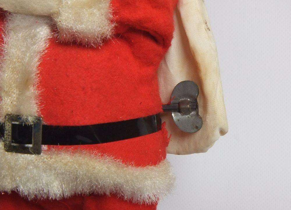 A FUNKY TALL VINTAGE TINPLATE AND CLOTH WIND UP SANTA CLAUS , WORKING BUT NOT NOISY