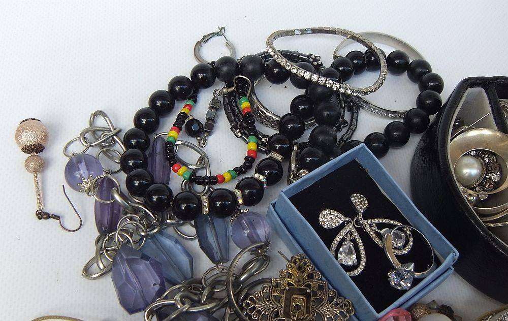 A rusty old tin filled with loads of usable jewelry and spare parts