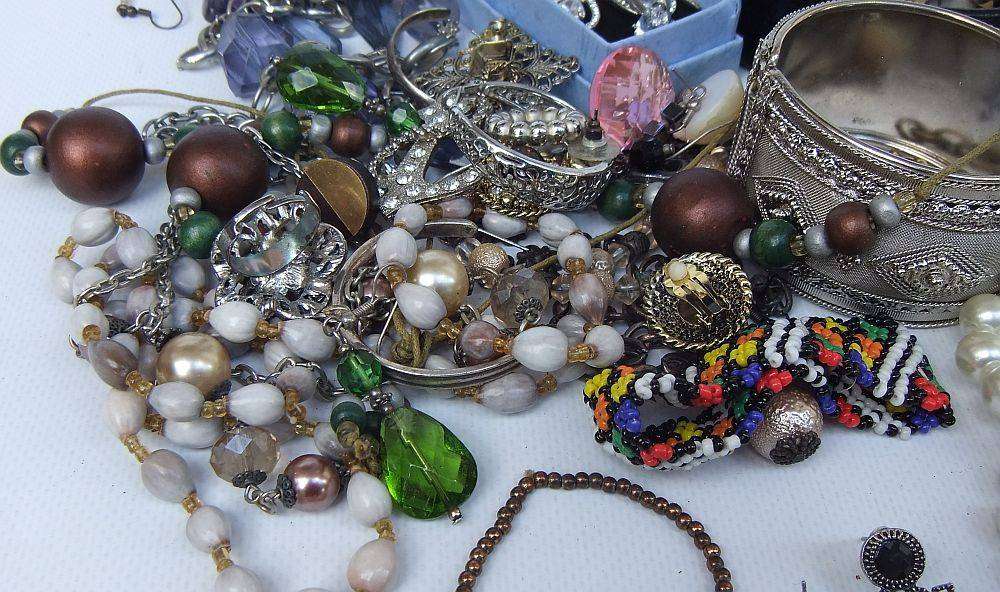 A rusty old tin filled with loads of usable jewelry and spare parts