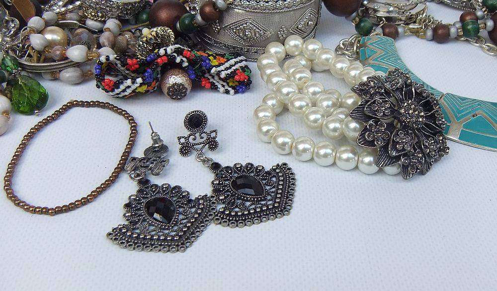 A rusty old tin filled with loads of usable jewelry and spare parts