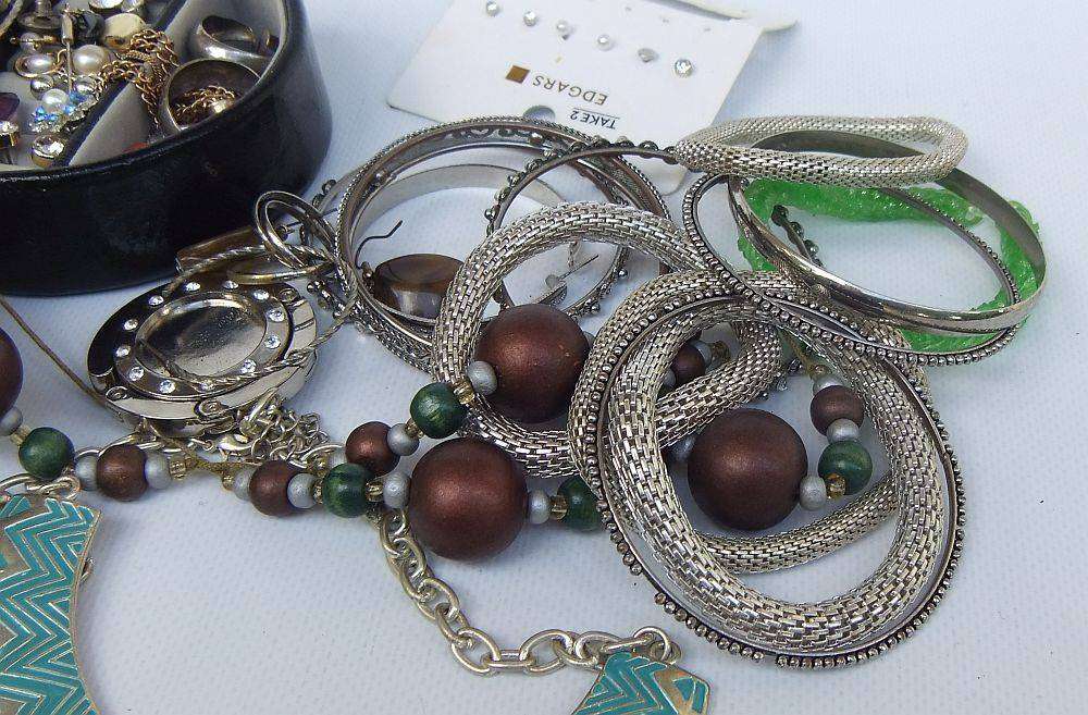 A rusty old tin filled with loads of usable jewelry and spare parts