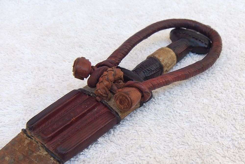 A RARE ANTIQUE DAGGER OF THE NORTH AFRICAN TUAREG TRIBE COVERED WITH GENUINE SNAKESKIN AND LEATHER
