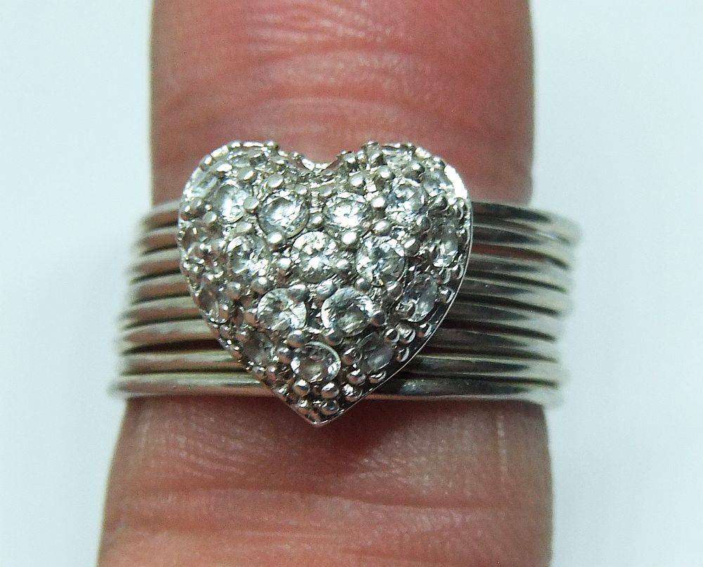 A beautiful sterling silver 8 in 1 ring with heart feature set with faceted clear CZ stones