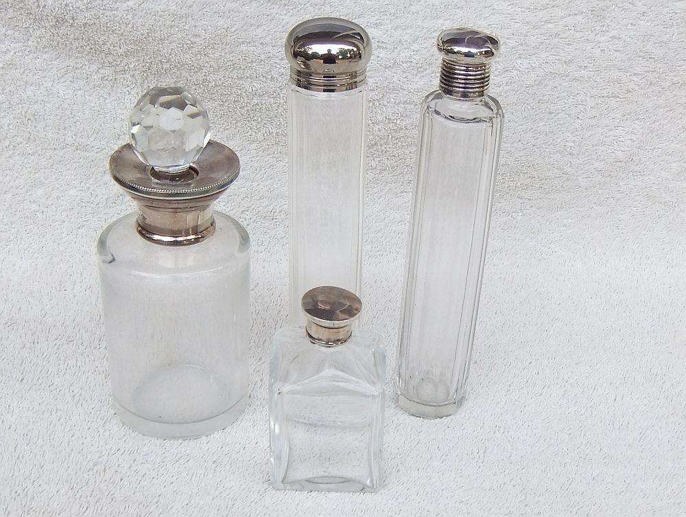 AN ANTIQUE BOTTLE WITH HALLMARKED SILVER COLLAR DATED 1918 , ANOTHER WITH SILVER LID PLUS 2 MORE !!