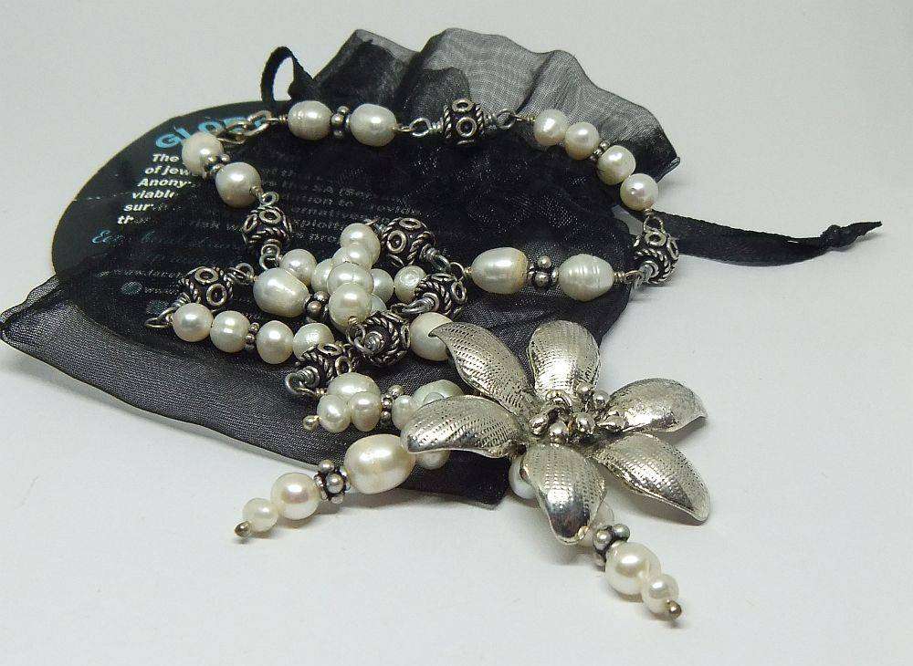 A beautiful hand made genuine pearl and metal bead necklace by Global Wonders in unworn condition