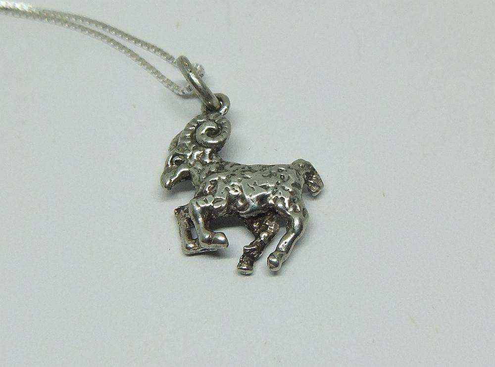 A vintage solid silver Aries Zodiac sign pendant with a sterling silver necklace