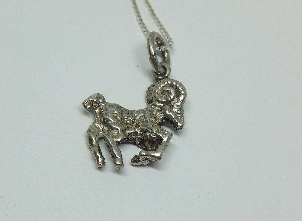 A vintage solid silver Aries Zodiac sign pendant with a sterling silver necklace