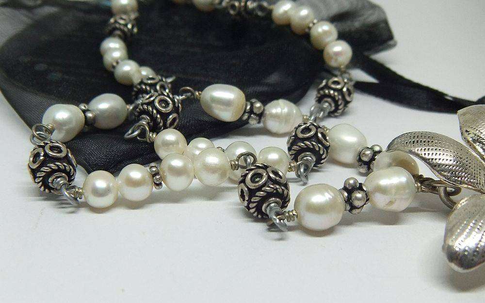 A beautiful hand made genuine pearl and metal bead necklace by Global Wonders in unworn condition