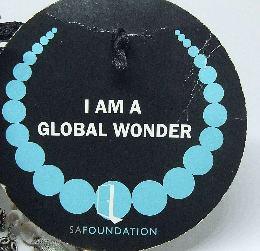 A beautiful hand made genuine pearl and metal bead necklace by Global Wonders in unworn condition