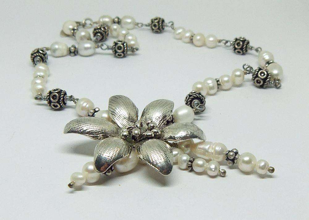 A beautiful hand made genuine pearl and metal bead necklace by Global Wonders in unworn condition