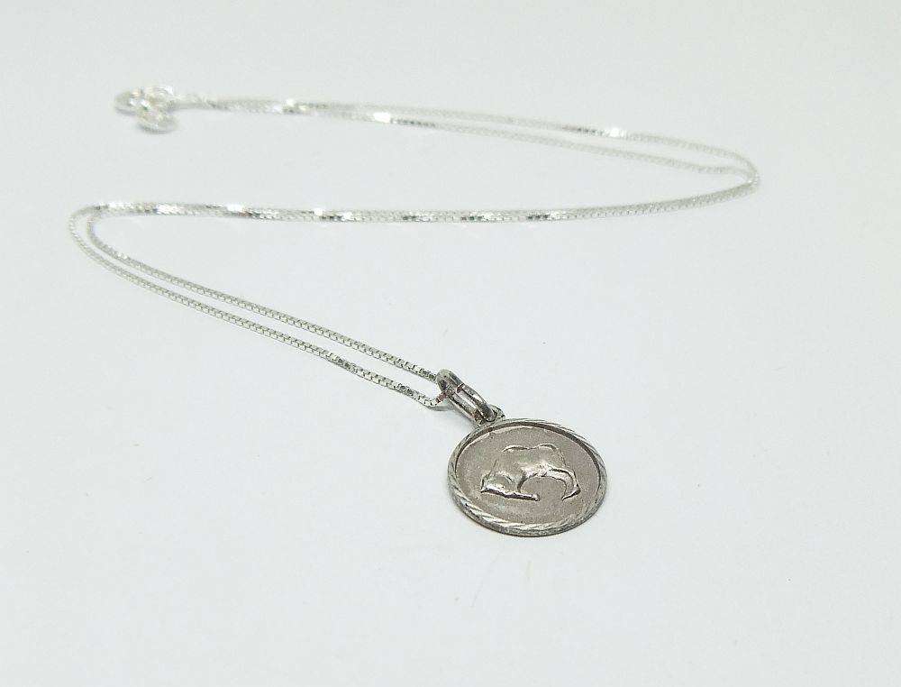 A vintage sterling silver Taurus Zodiac sign pendant plus a sterling silver necklace