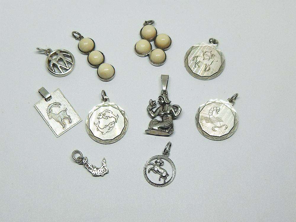 A lot of 9 vintage solid silver pendants and one sterling silver island charm