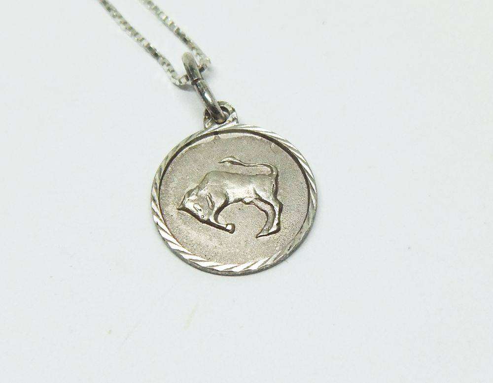 A vintage sterling silver Taurus Zodiac sign pendant plus a sterling silver necklace