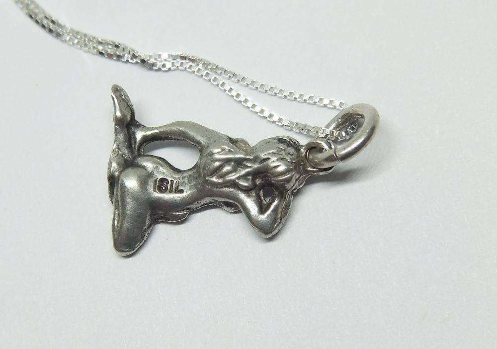 A vintage solid silver Virgo Zodiac sign pendant with a sterling silver necklace