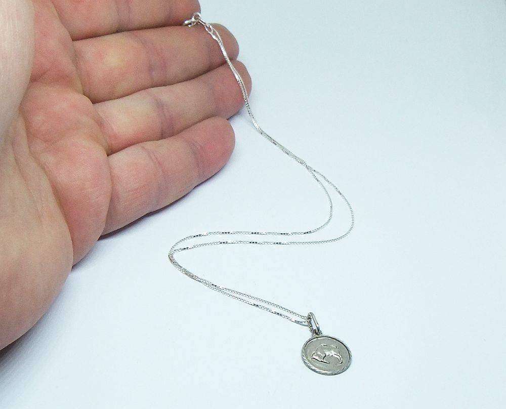 A vintage sterling silver Taurus Zodiac sign pendant plus a sterling silver necklace