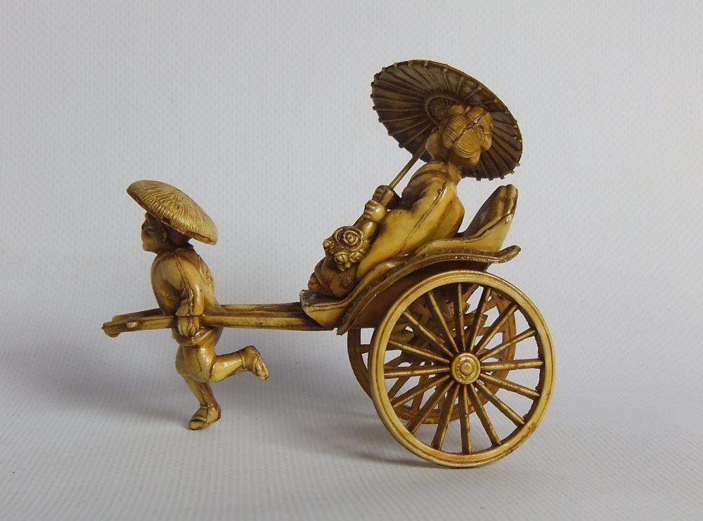 A HIGHLY DETAILED AND DELICATE VINTAGE JAPANESE CELLULOID RICKSHAW AND GEISHA ORIENTAL FIGURINE