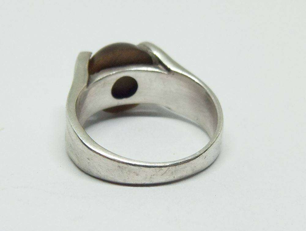 A superior quality vintage sterling silver ring set with a cabochon genuine Tigers eye stone