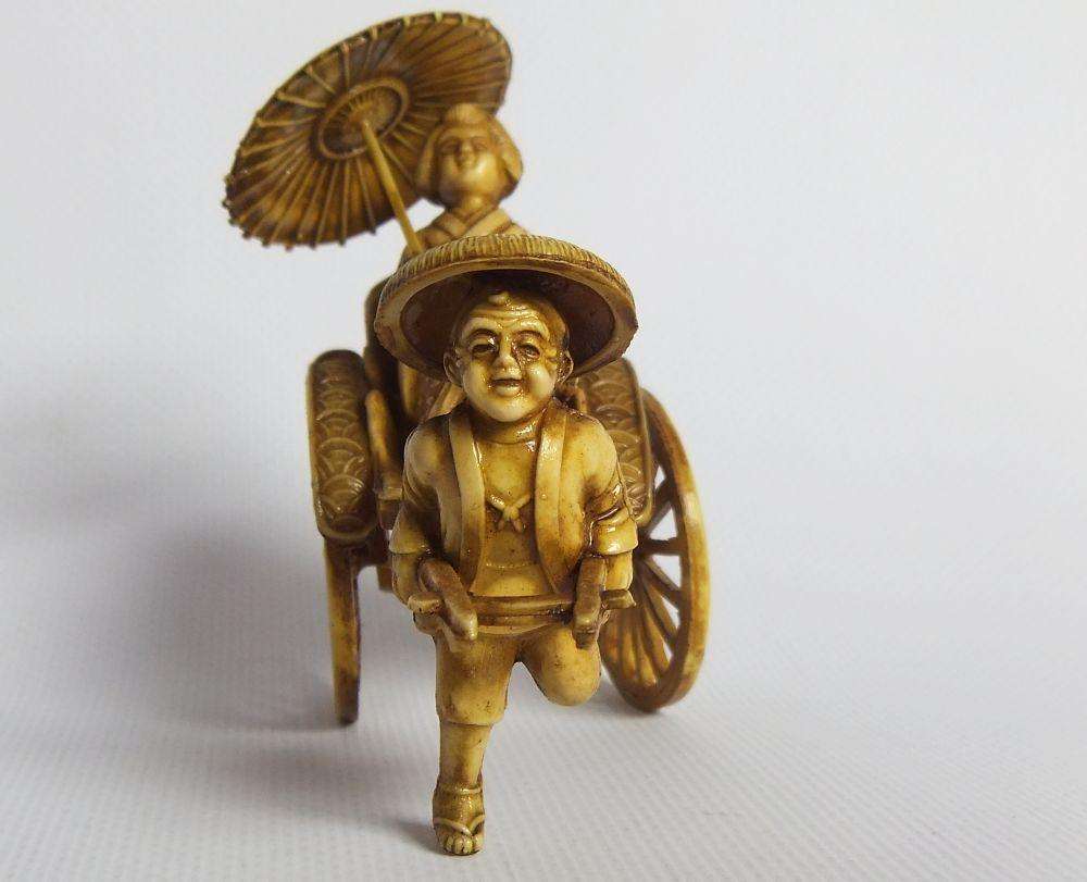 A HIGHLY DETAILED AND DELICATE VINTAGE JAPANESE CELLULOID RICKSHAW AND GEISHA ORIENTAL FIGURINE